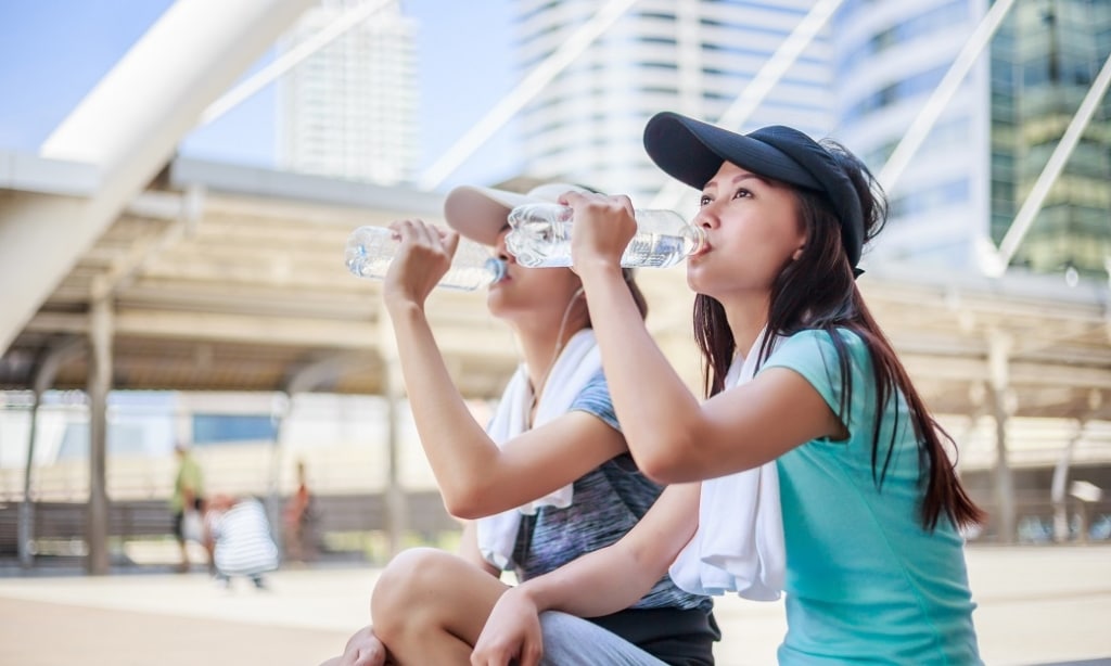 two young women drink water