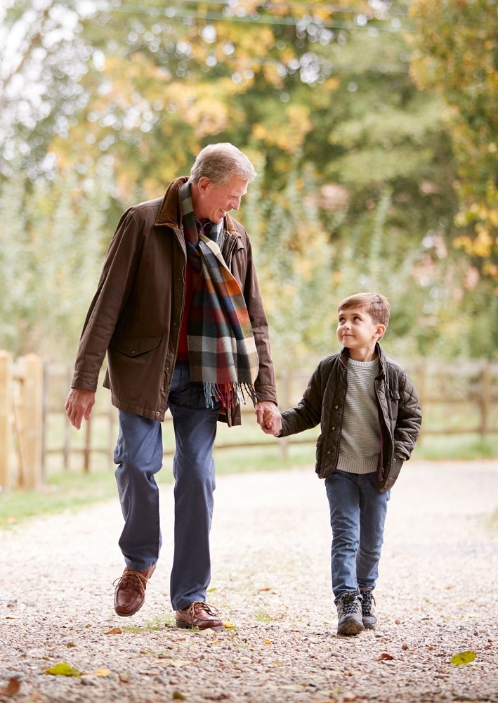 a father or grandfather walks with a boy