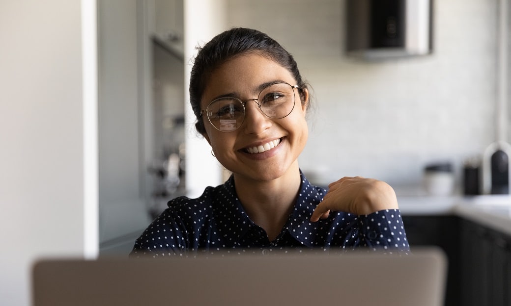 a volunteer smiles cheerfully from behind her computer